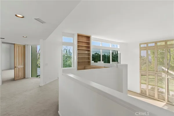a view of an empty room with windows