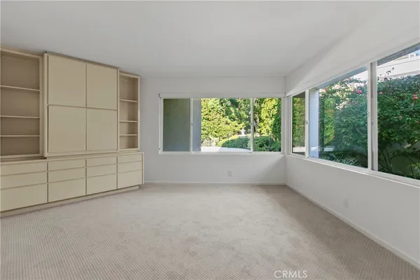 an empty room with large windows