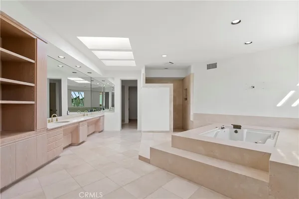 a large bathroom with a large tub and sink
