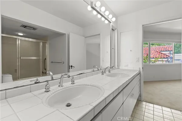 a bathroom with a double vanity sink mirror and double