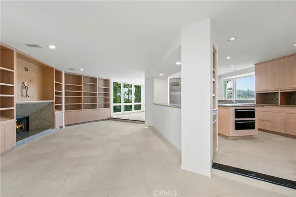 a view of a kitchen with furniture and an empty room