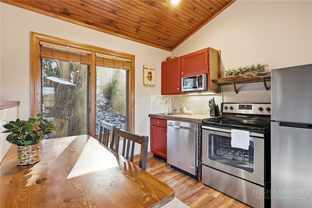 140 Lindale Ridge, Unit 504 Boone, NC 28607 - Photo 5 of 15 a kitchen with stainless steel appliances granite countertop a stove a sink and a refrigerator