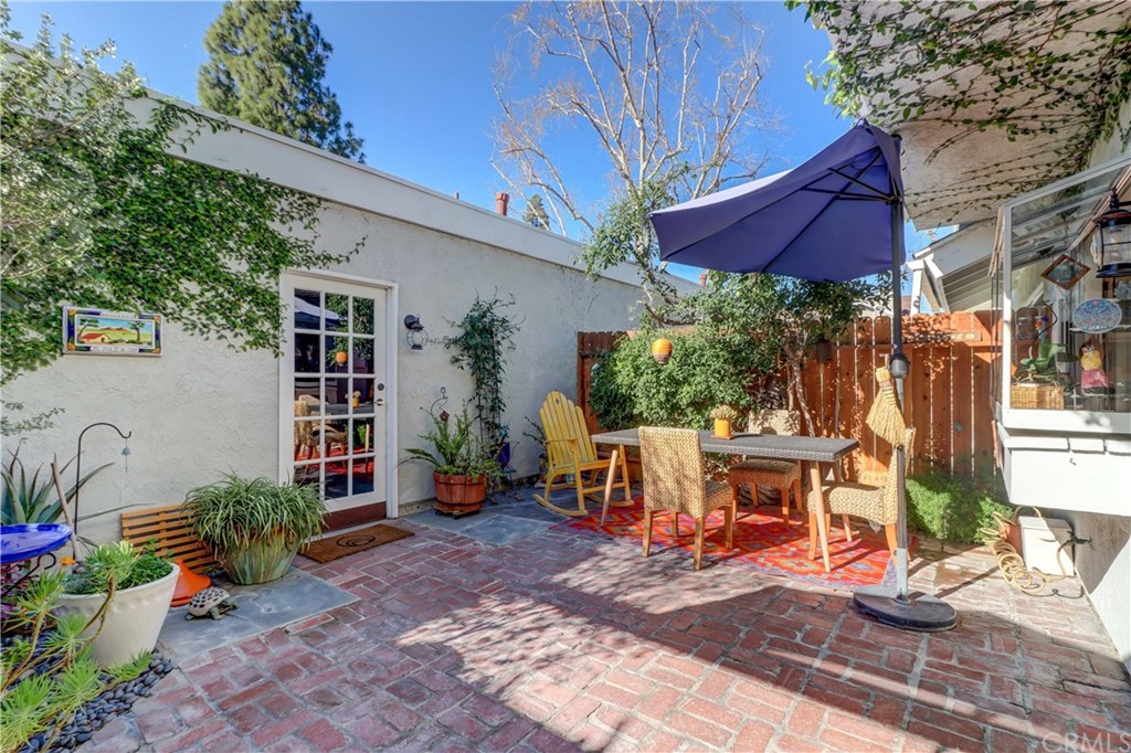 3 Sunflower, Unit 27 Irvine, CA 92604 - Photo 12 of 47 a view of a patio with table and chairs under an umbrella
