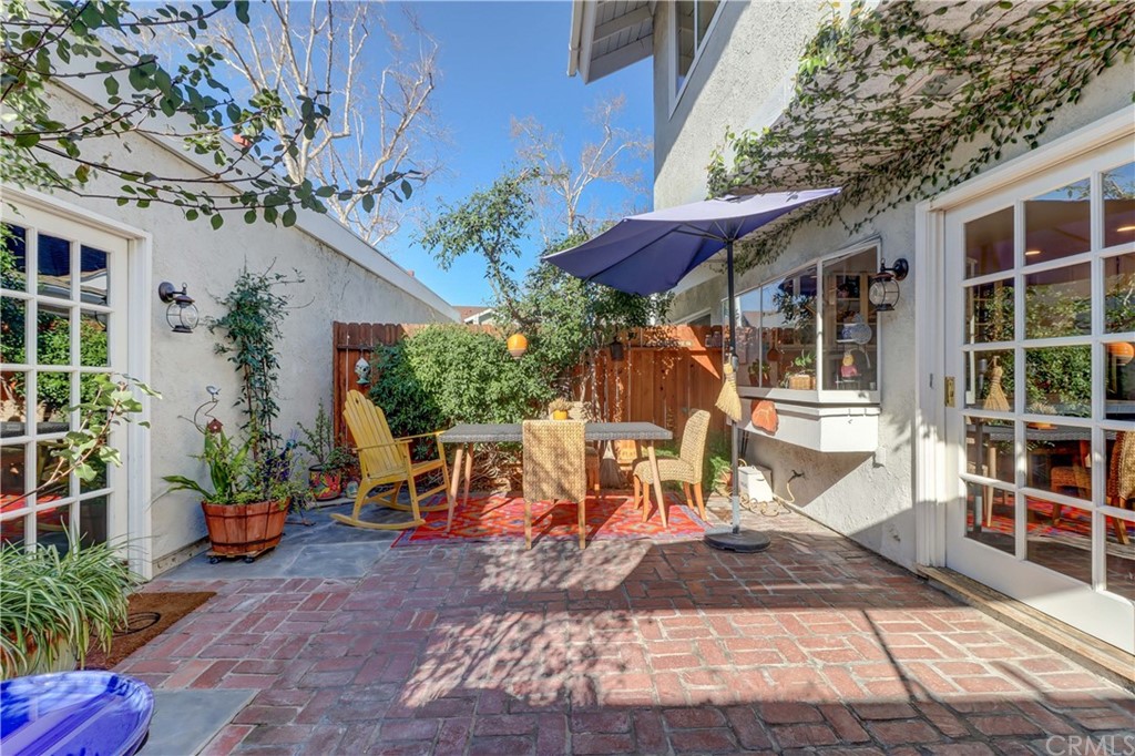 3 Sunflower, Unit 27 Irvine, CA 92604 - Photo 13 of 47 a view of a patio with table and chairs potted plants and large tree