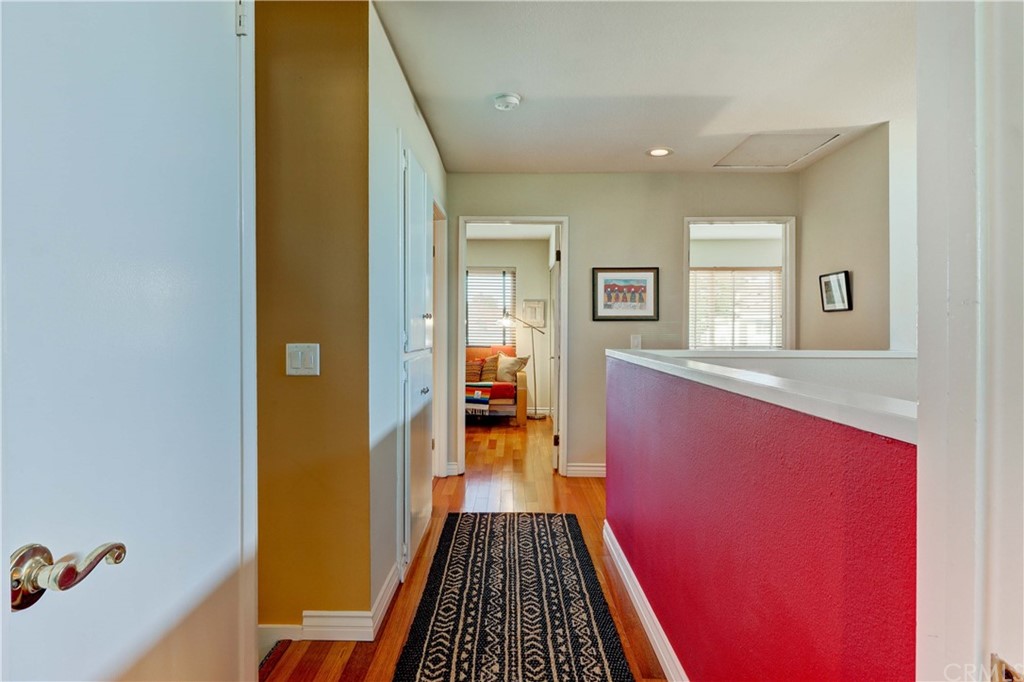 3 Sunflower, Unit 27 Irvine, CA 92604 - Photo 21 of 47 a view of a hallway with wooden floor and a living room