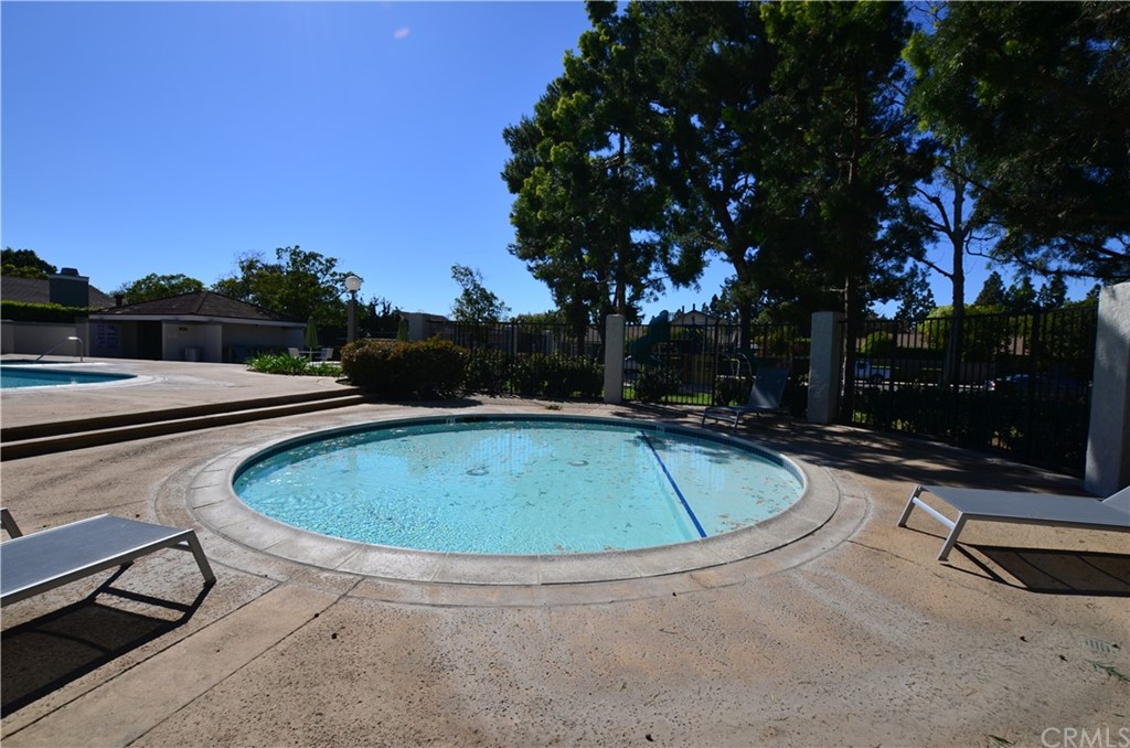 3 Sunflower, Unit 27 Irvine, CA 92604 - Photo 35 of 47 a view of a swimming pool with a yard and trees