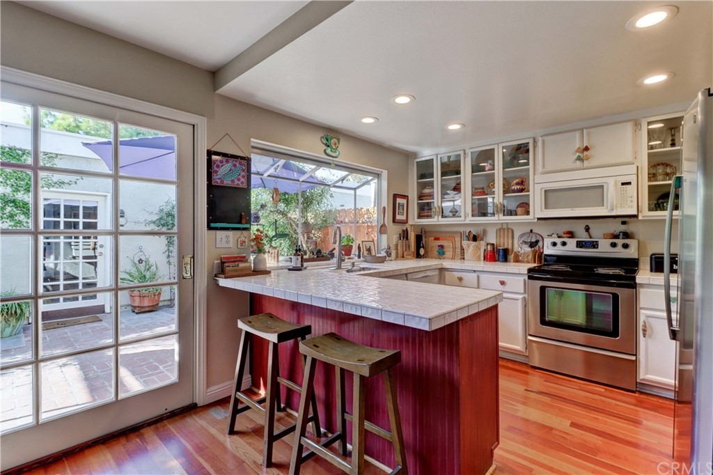 3 Sunflower, Unit 27 Irvine, CA 92604 - Photo 7 of 47 a kitchen with stainless steel appliances granite countertop a stove and a refrigerator