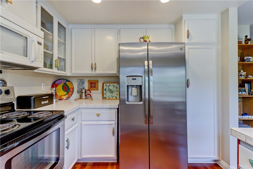 3 Sunflower, Unit 27 Irvine, CA 92604 - Photo 9 of 47 a kitchen with stainless steel appliances granite countertop a refrigerator and a stove