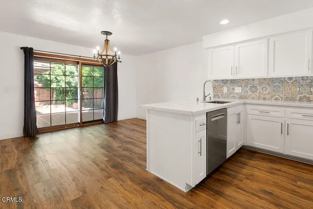 a kitchen with stainless steel appliances a refrigerator stove and sink