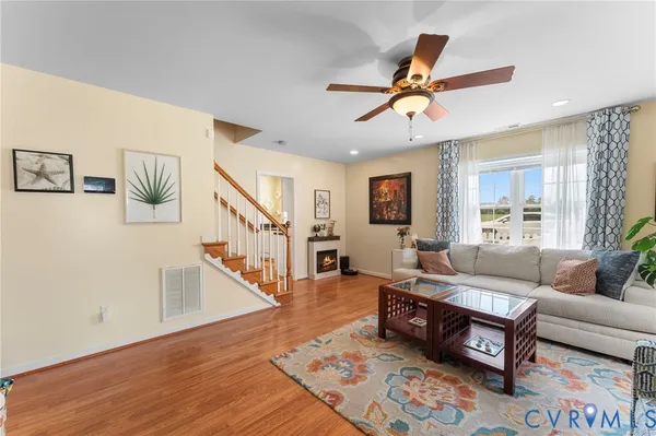 a living room with furniture and wooden floor