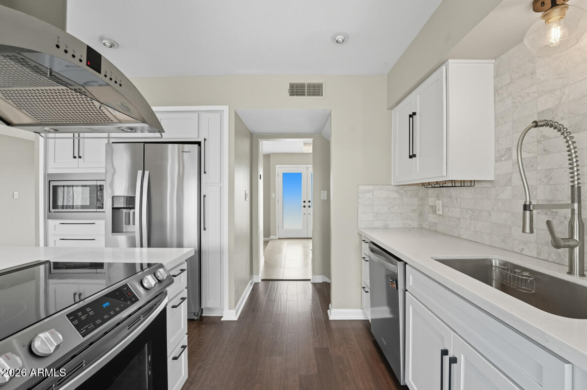 8437 East Thomas Road Scottsdale, AZ 85251 - Photo 11 of 55 a kitchen with stainless steel appliances a sink stove and refrigerator