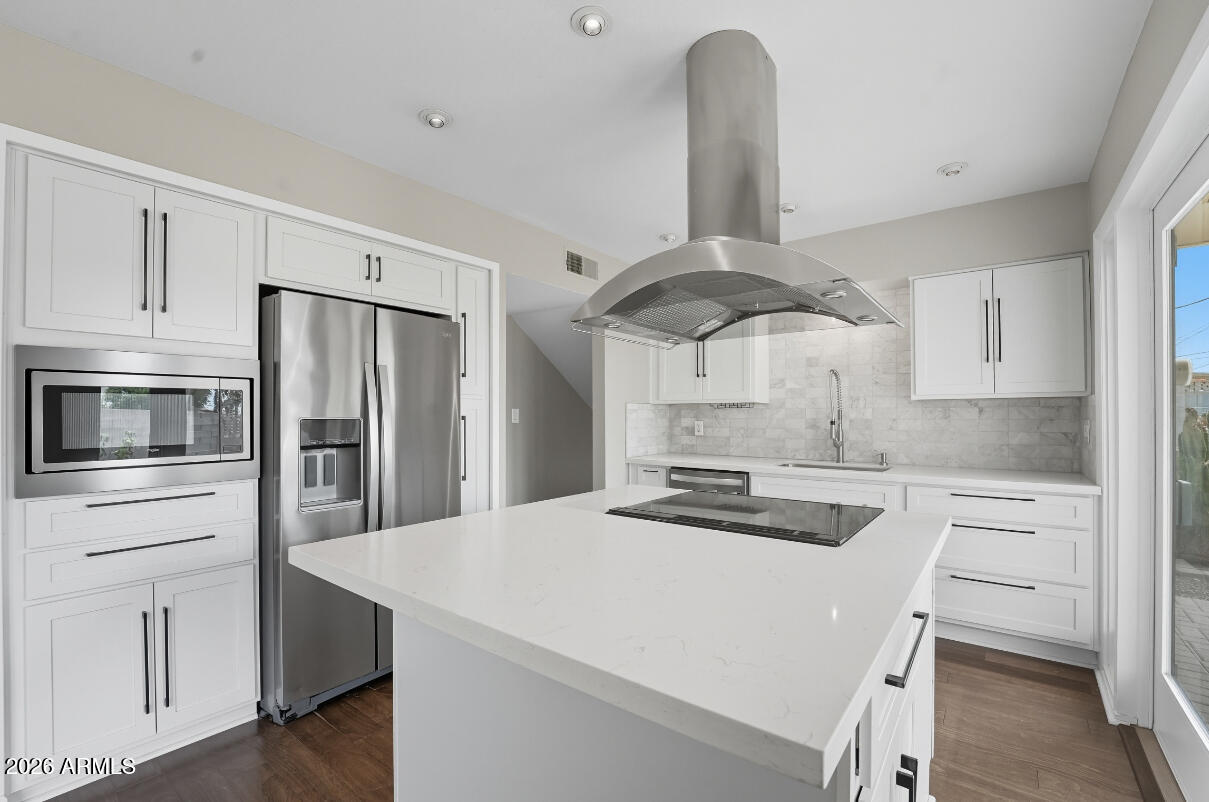 8437 East Thomas Road Scottsdale, AZ 85251 - Photo 14 of 55 a kitchen with stainless steel appliances a refrigerator a stove a sink and white cabinets