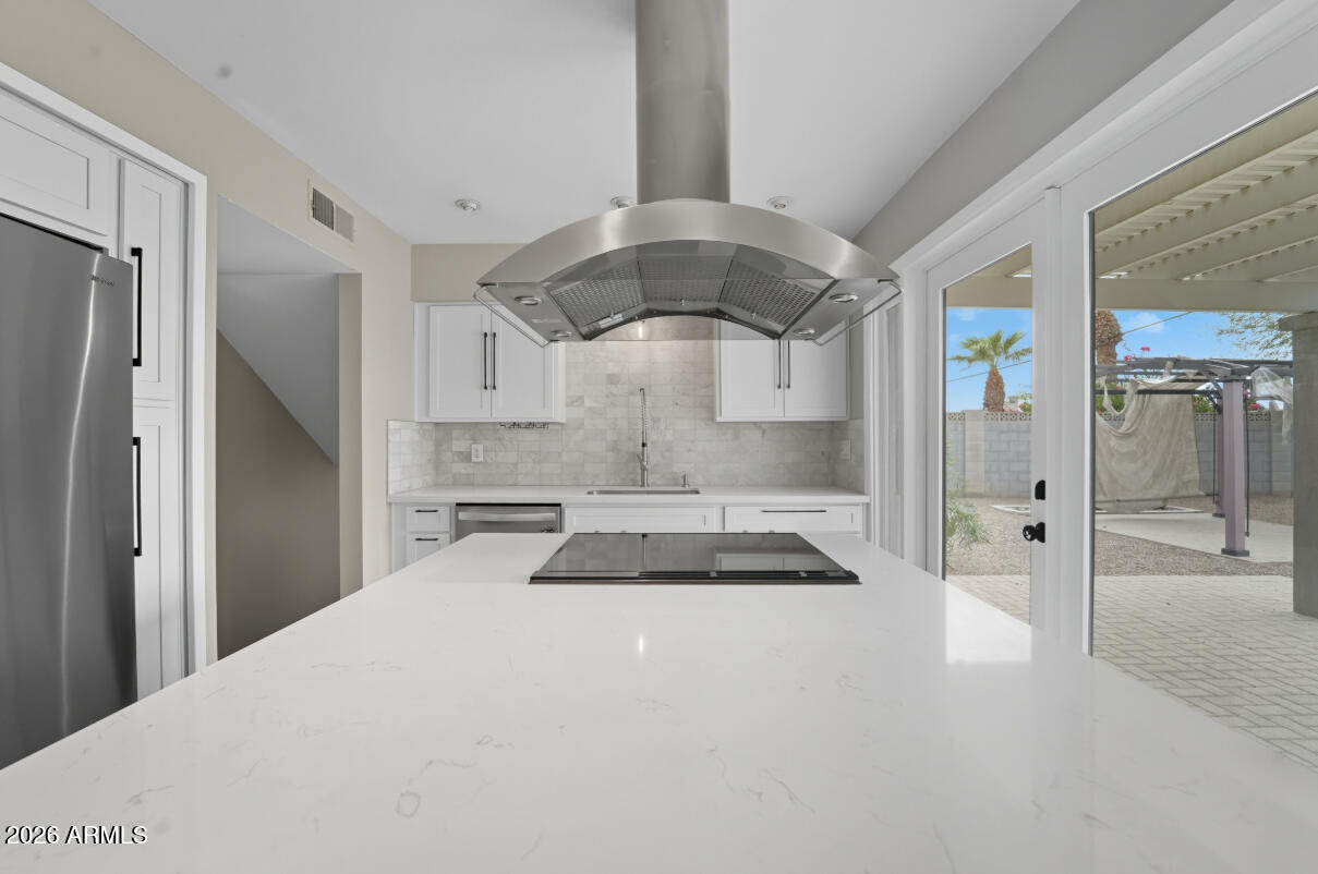 8437 East Thomas Road Scottsdale, AZ 85251 - Photo 16 of 55 a bedroom with a large bed and a chandelier