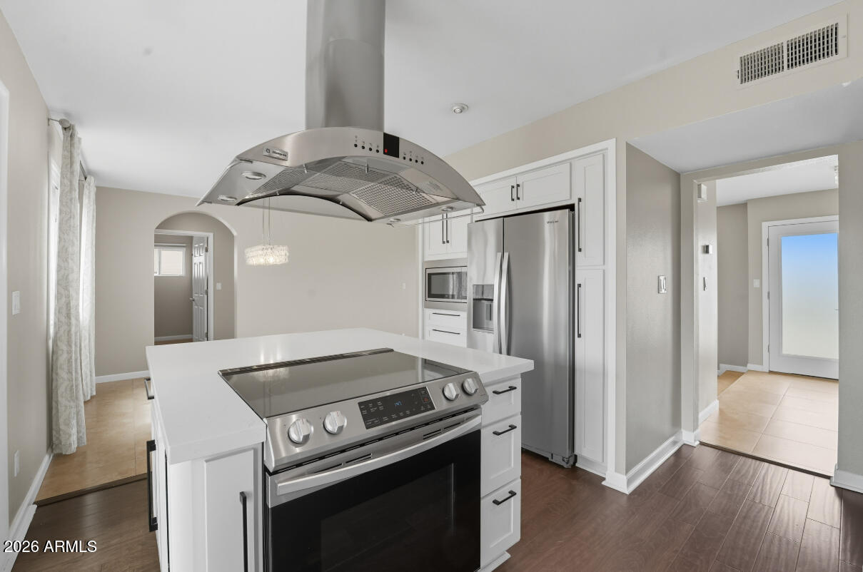 8437 East Thomas Road Scottsdale, AZ 85251 - Photo 18 of 55 a kitchen with stainless steel appliances granite countertop a stove and a refrigerator