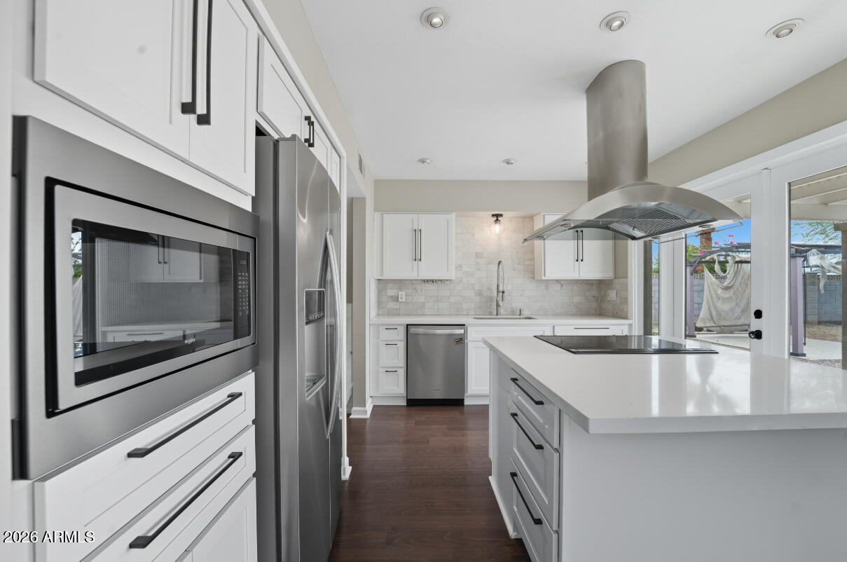 8437 East Thomas Road Scottsdale, AZ 85251 - Photo 19 of 55 a kitchen with a sink a counter top space stainless steel appliances and cabinets