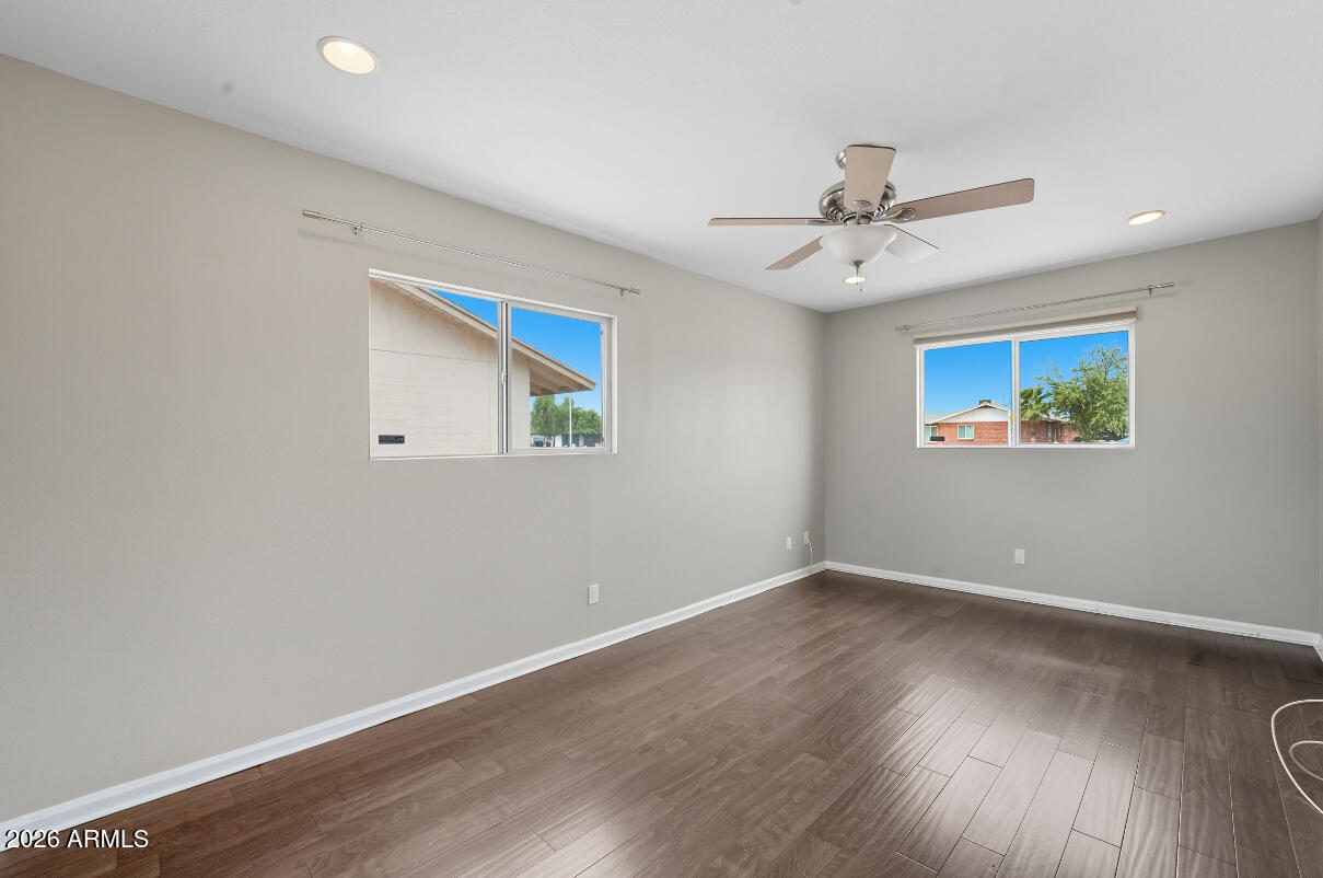 8437 East Thomas Road Scottsdale, AZ 85251 - Photo 23 of 55 an empty room with wooden floor ceiling fan and window