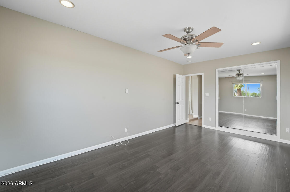 8437 East Thomas Road Scottsdale, AZ 85251 - Photo 25 of 55 an empty room with wooden floor fan and windows