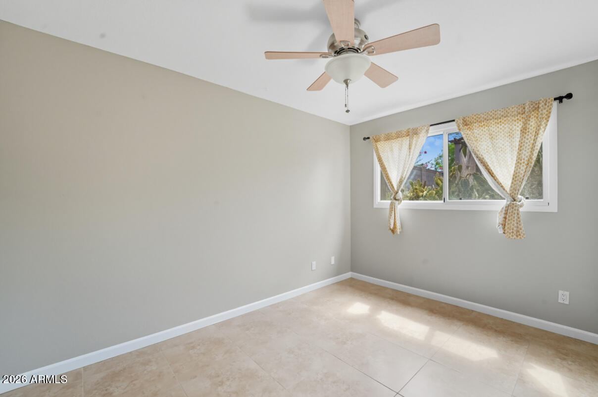 8437 East Thomas Road Scottsdale, AZ 85251 - Photo 30 of 55 an empty room with windows and fan