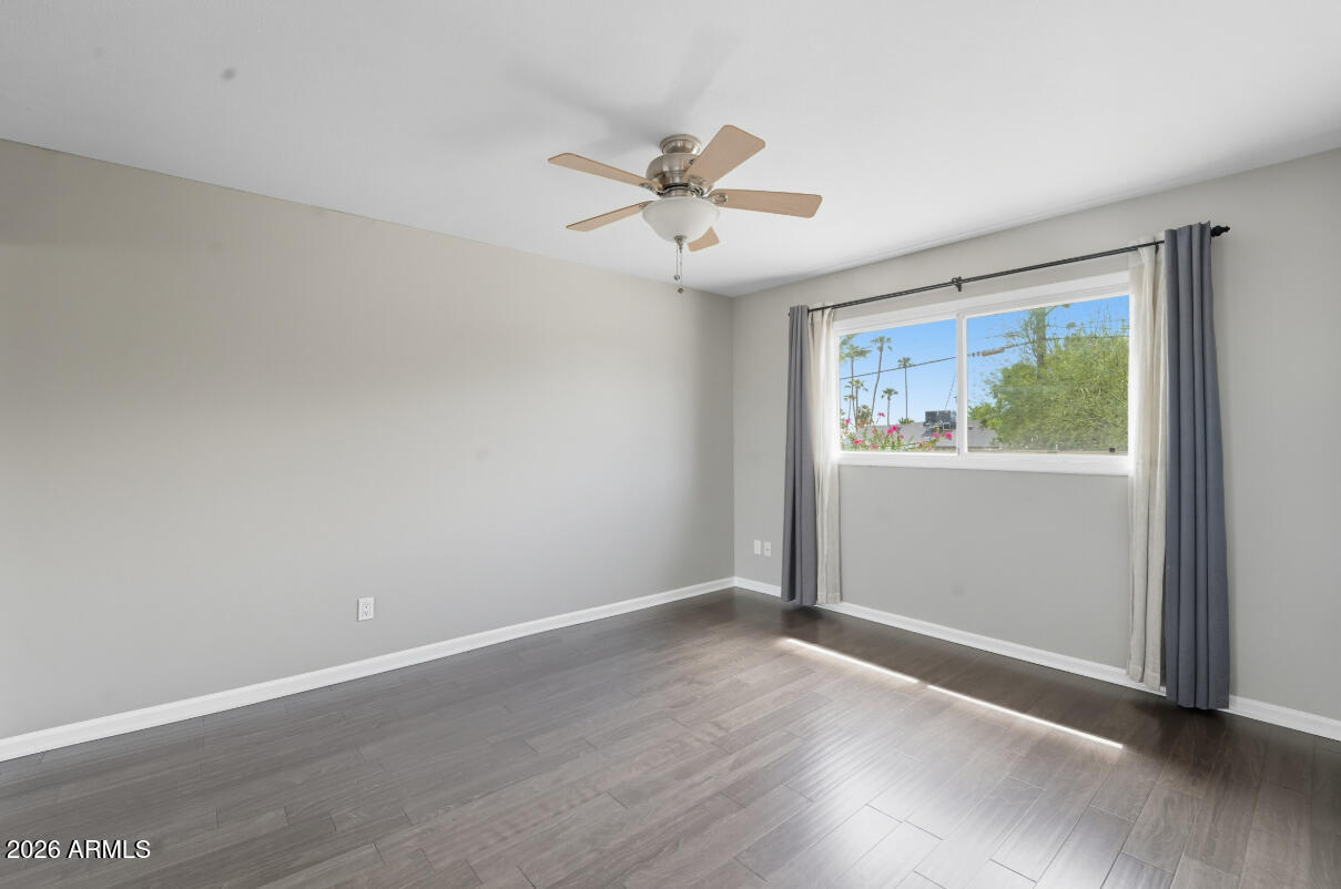 8437 East Thomas Road Scottsdale, AZ 85251 - Photo 35 of 55 an empty room with wooden floor fan and windows