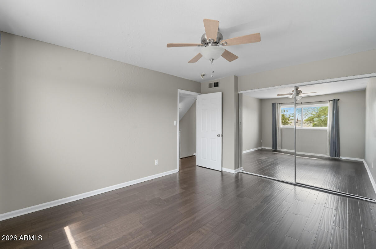 8437 East Thomas Road Scottsdale, AZ 85251 - Photo 36 of 55 an empty room with wooden floor and ceiling fan