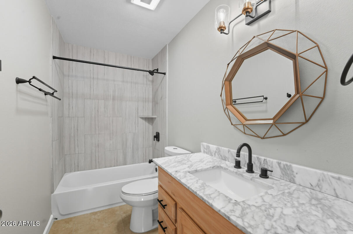 8437 East Thomas Road Scottsdale, AZ 85251 - Photo 38 of 55 a bathroom with a granite countertop sink a toilet and a mirror