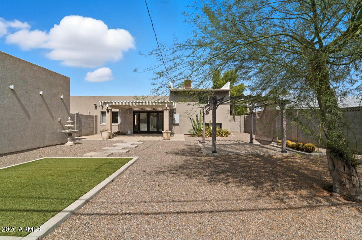 8437 East Thomas Road Scottsdale, AZ 85251 - Photo 44 of 55 a view of a house with a backyard and a tree