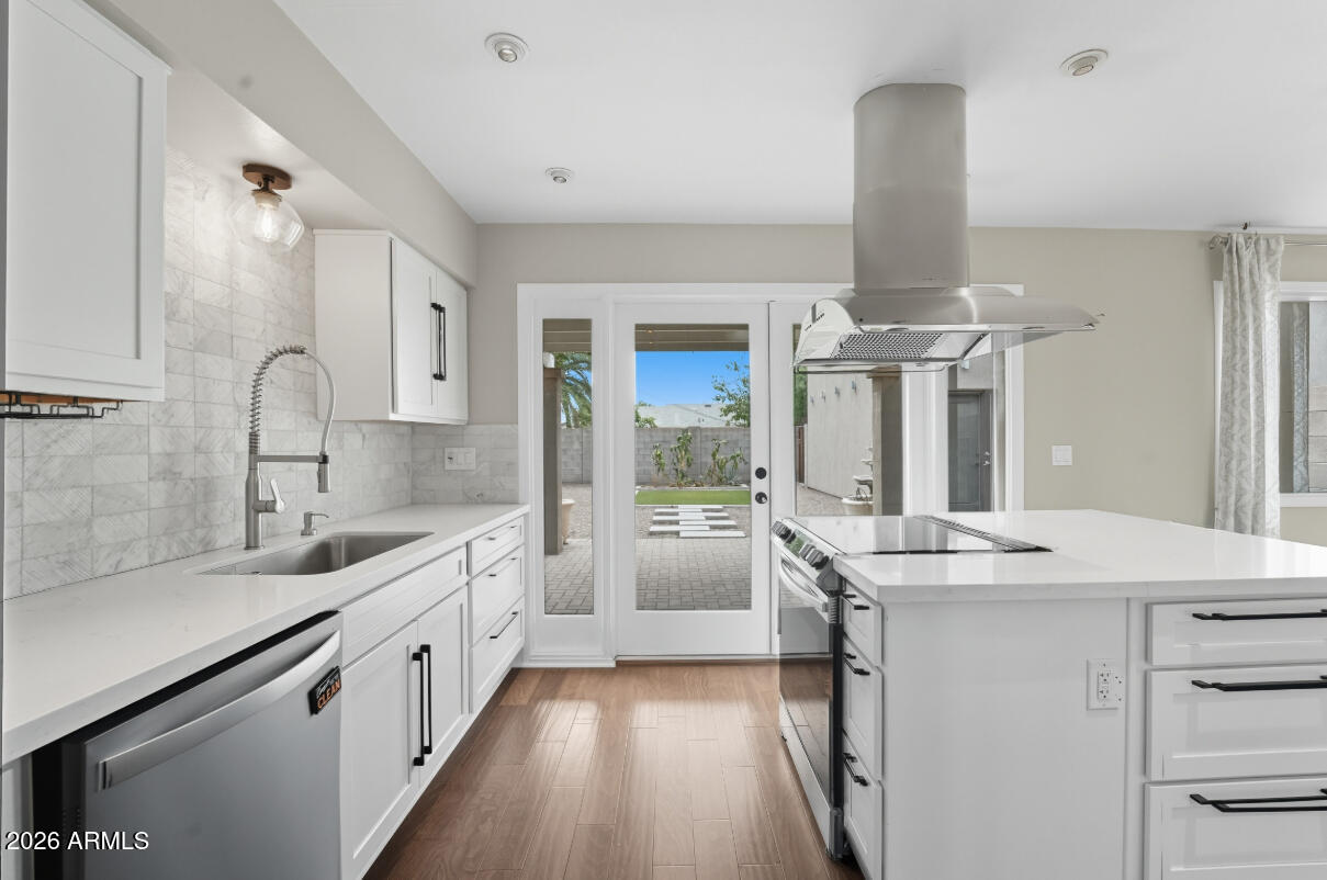 8437 East Thomas Road Scottsdale, AZ 85251 - Photo 10 of 55 a kitchen with granite countertop a sink stainless steel appliances and cabinets