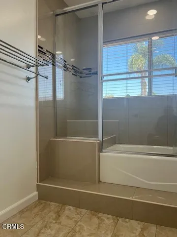 a bathroom with a bathtub and a shower