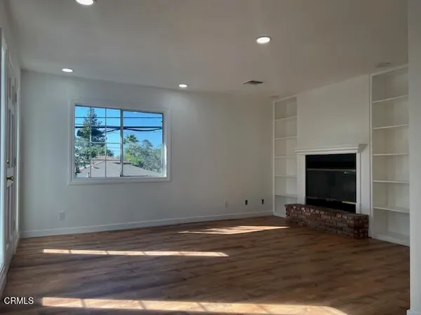 a view of room with wooden floor and window