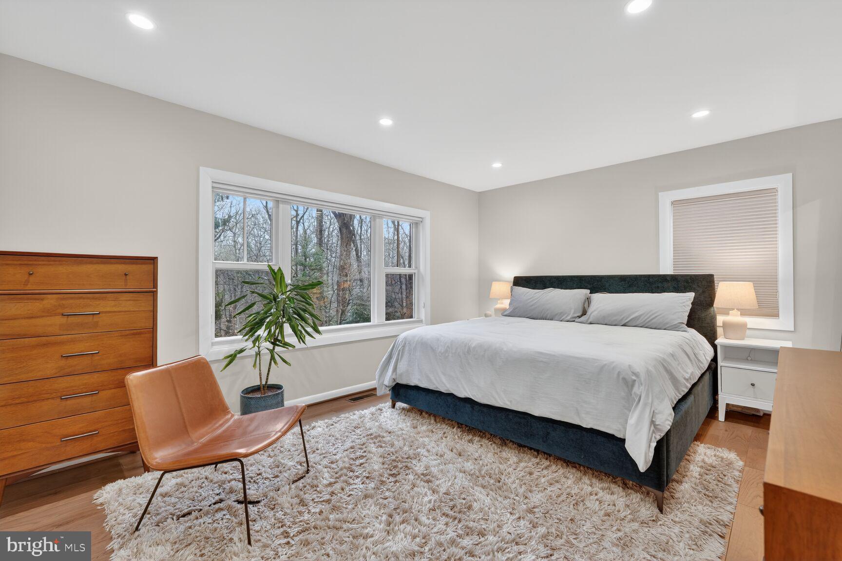 5908 17th Street Northwest Washington, DC 20011 - Photo 11 of 30 a spacious bedroom with a bed and chair chair