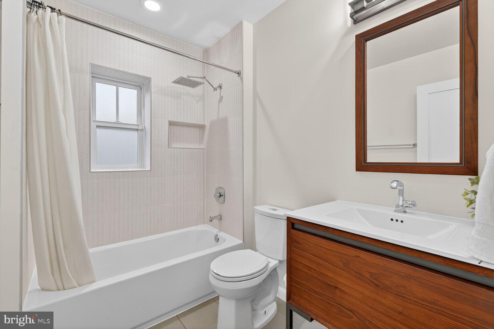 5908 17th Street Northwest Washington, DC 20011 - Photo 15 of 30 a bathroom with a sink a toilet and shower