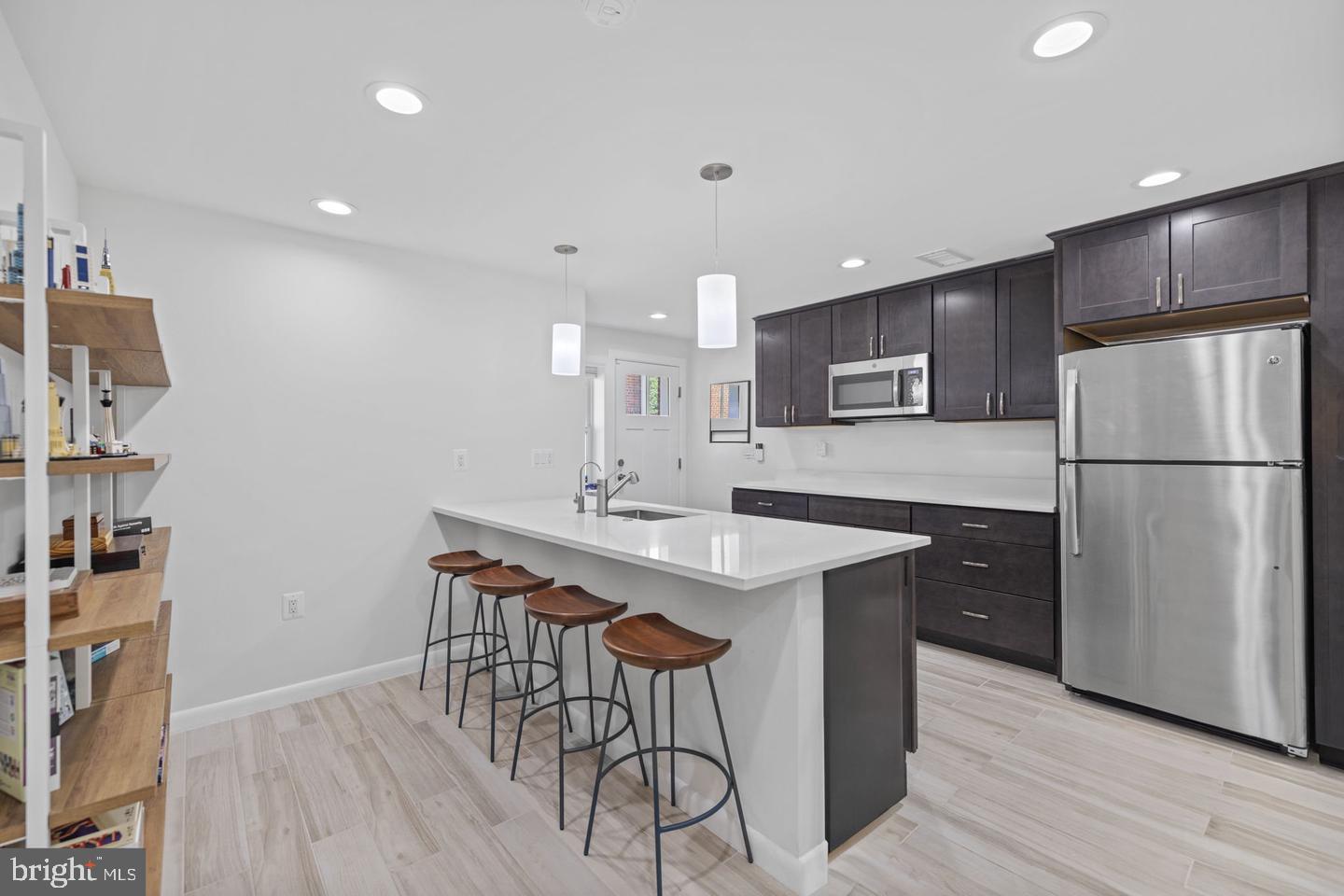 5908 17th Street Northwest Washington, DC 20011 - Photo 18 of 30 a kitchen with stainless steel appliances a sink cabinets a refrigerator and a stove