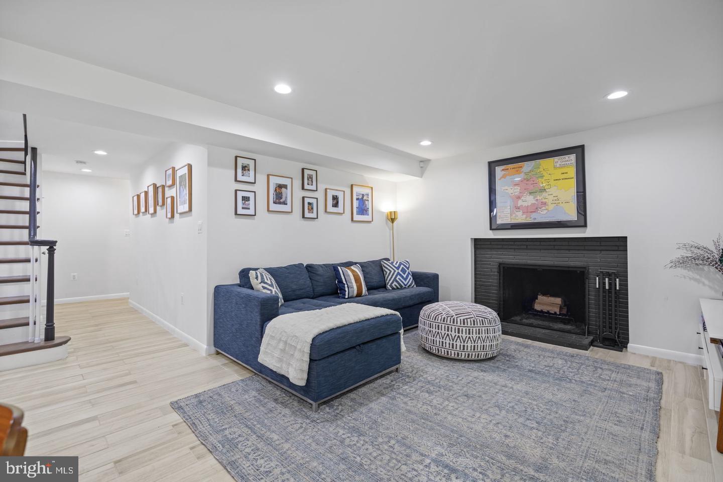 5908 17th Street Northwest Washington, DC 20011 - Photo 20 of 30 a living room with furniture and a fireplace