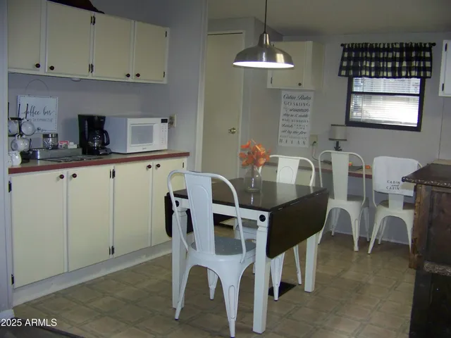 a kitchen with a refrigerator and cabinets