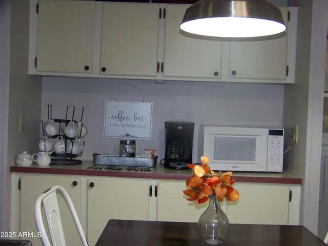 a kitchen with granite countertop a sink a stove and cabinets
