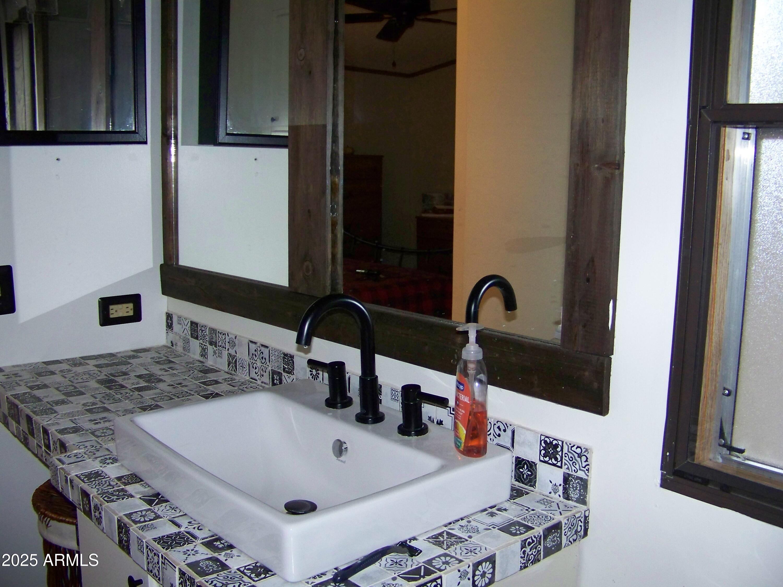 1167 White Tail Lane Pinetop, AZ 85935 - Photo 23 of 58 a bathroom with a sink and a mirror