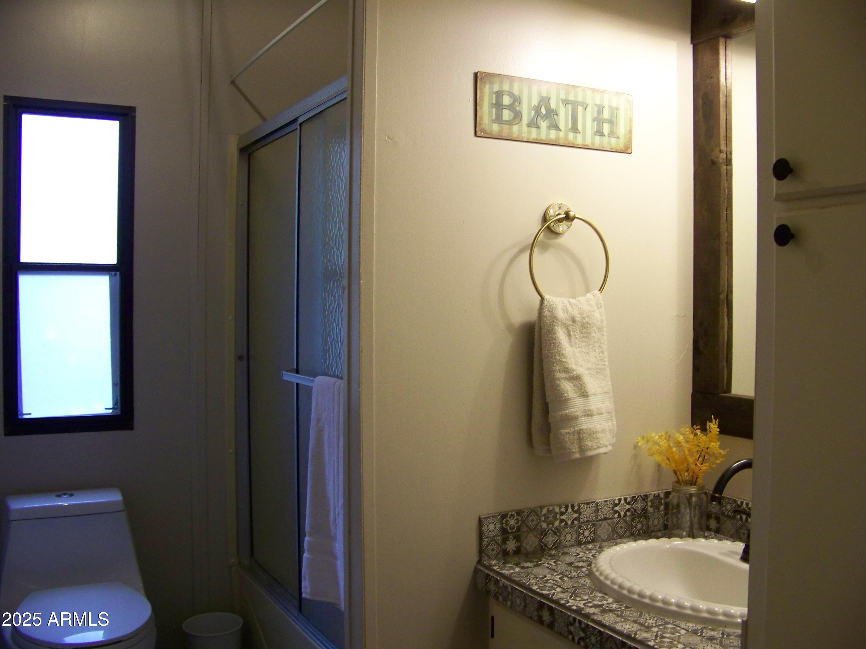 1167 White Tail Lane Pinetop, AZ 85935 - Photo 32 of 58 a bathroom with a granite countertop sink a toilet and a mirror