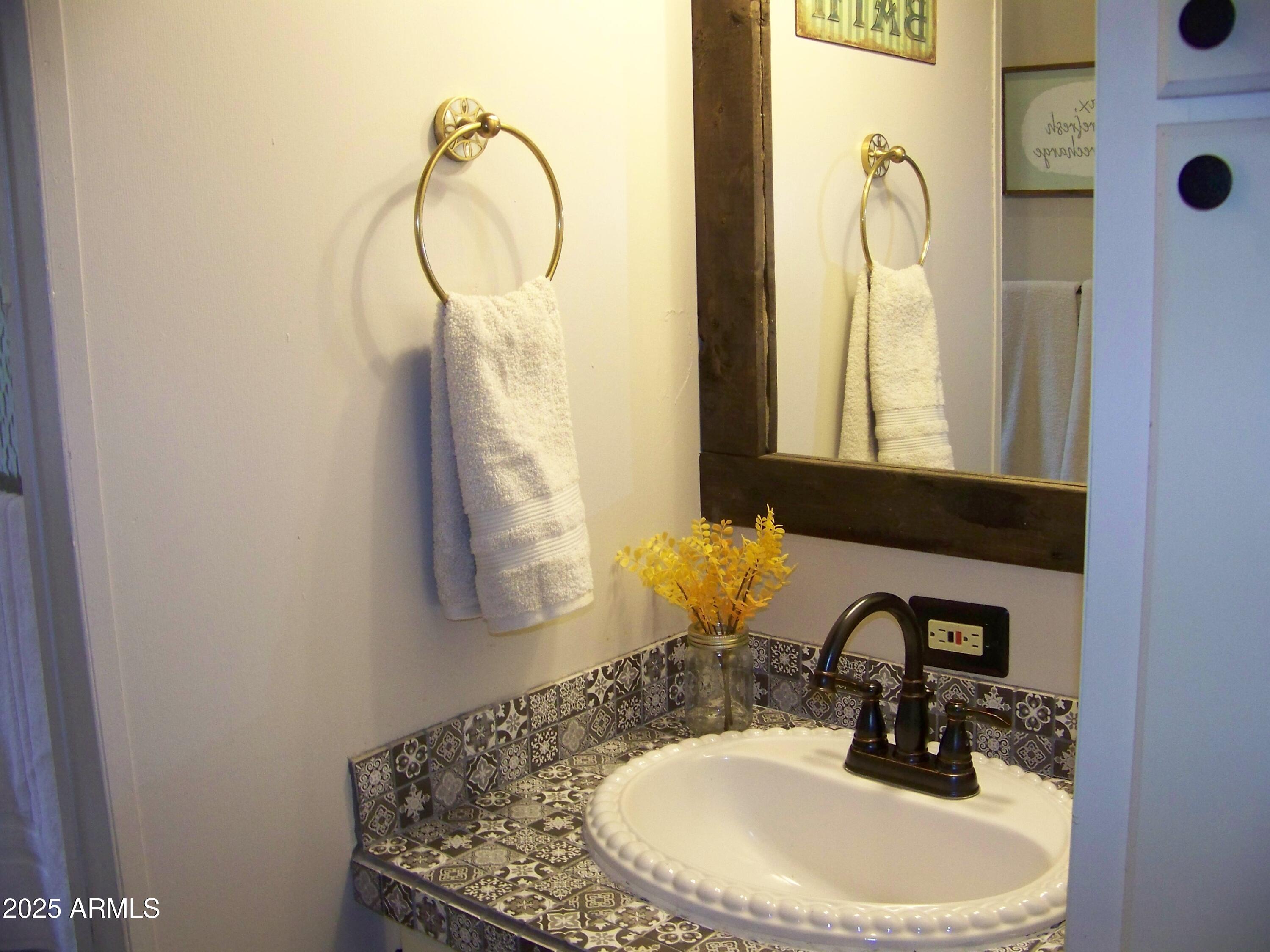 1167 White Tail Lane Pinetop, AZ 85935 - Photo 34 of 58 a bathroom with a sink and a mirror