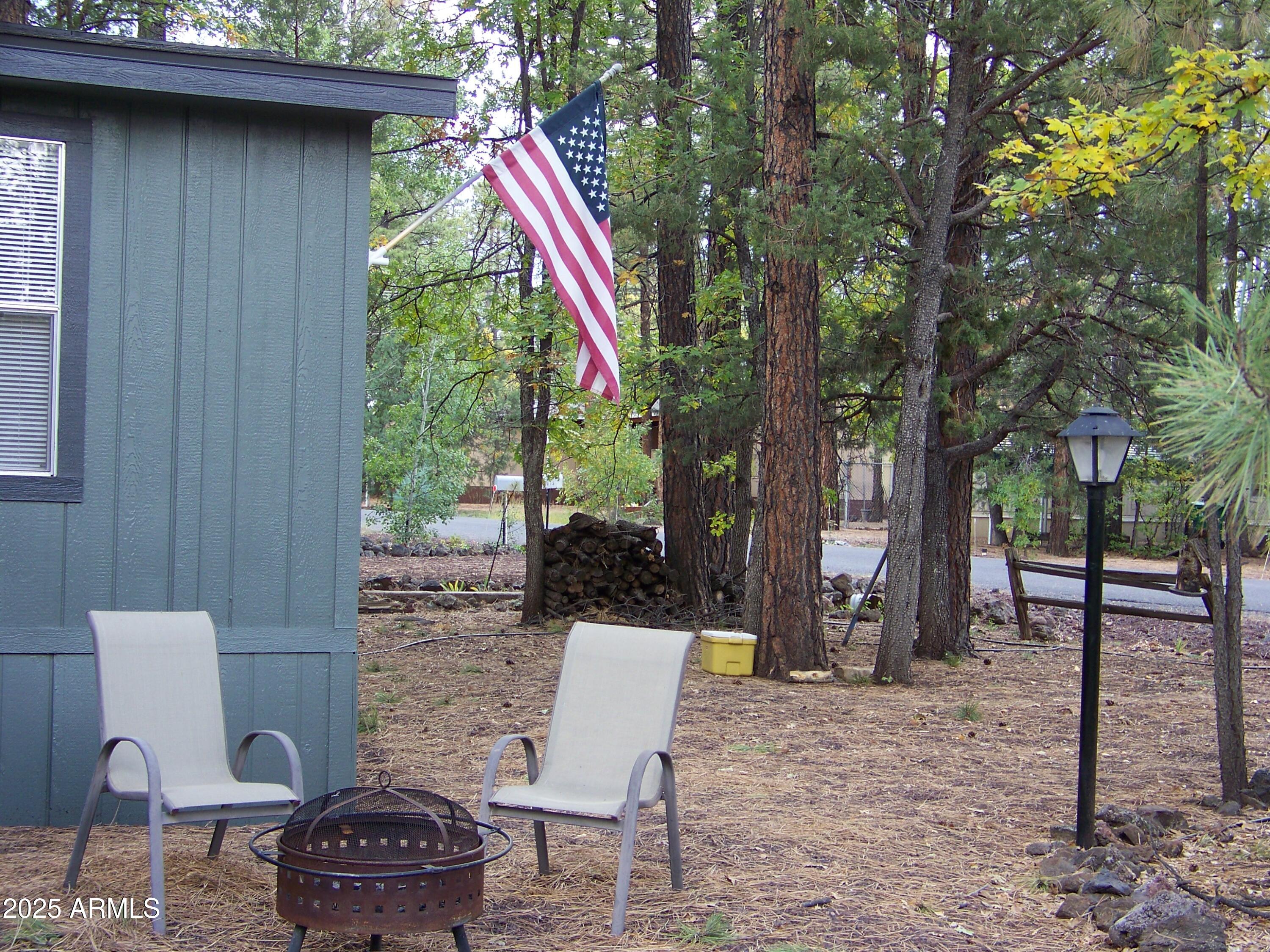 1167 White Tail Lane Pinetop, AZ 85935 - Photo 47 of 58 a backyard of a house with outdoor seating