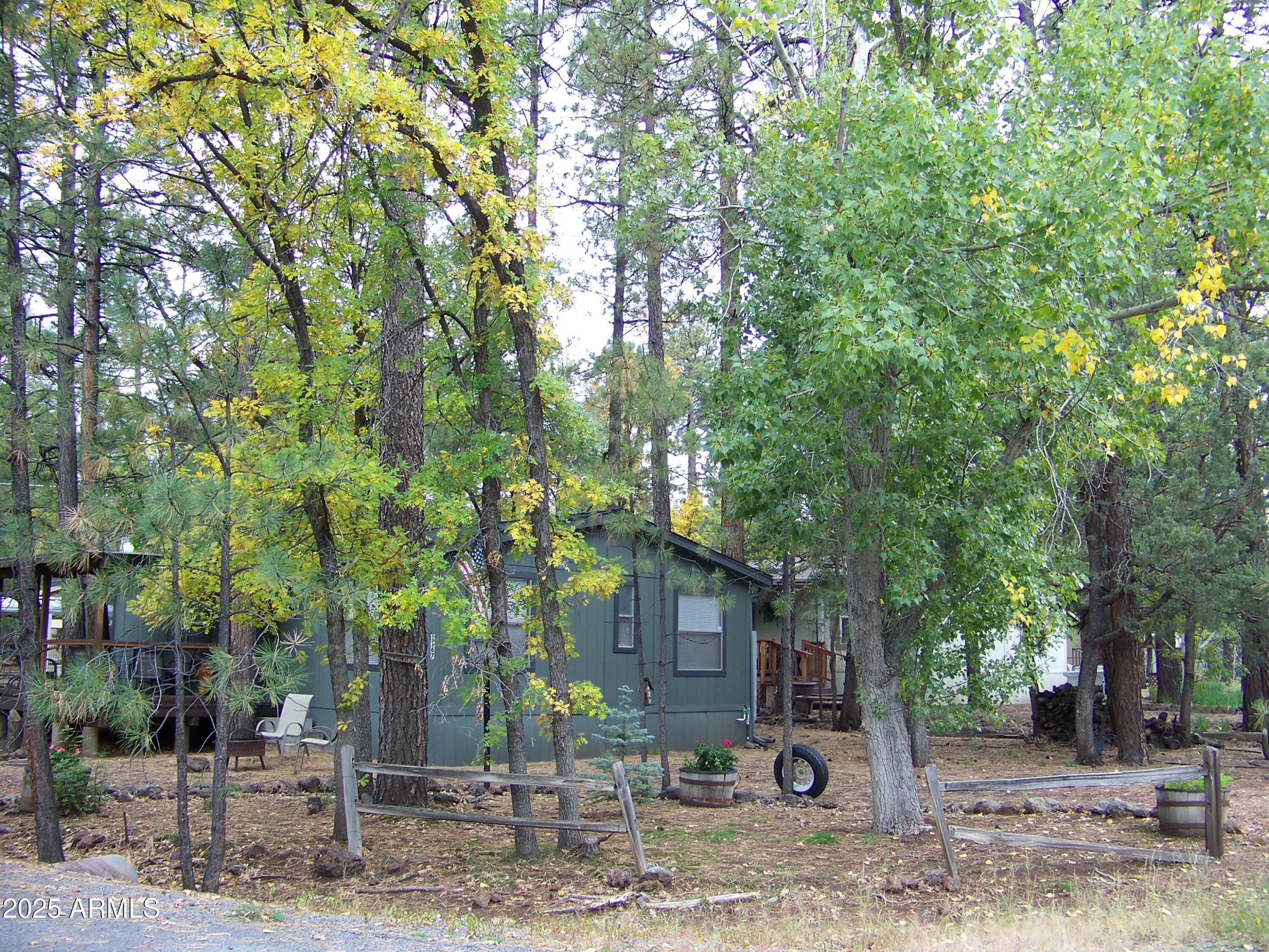1167 White Tail Lane Pinetop, AZ 85935 - Photo 49 of 58 a view of a tree in front of a house