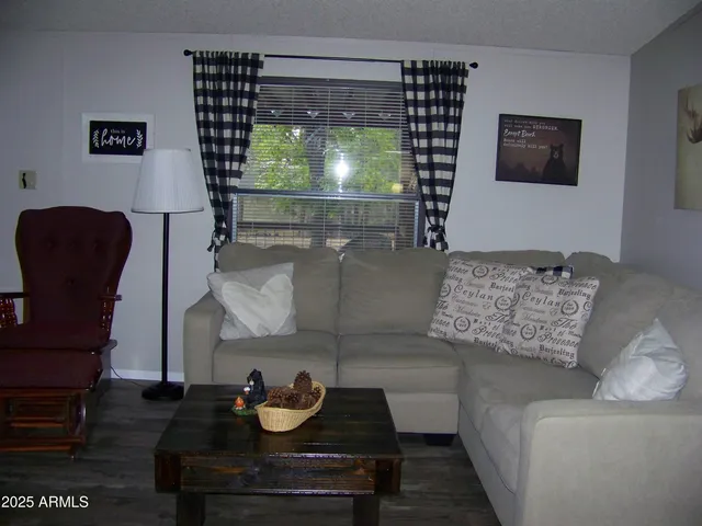 a kitchen with a sink cabinets and wooden floor