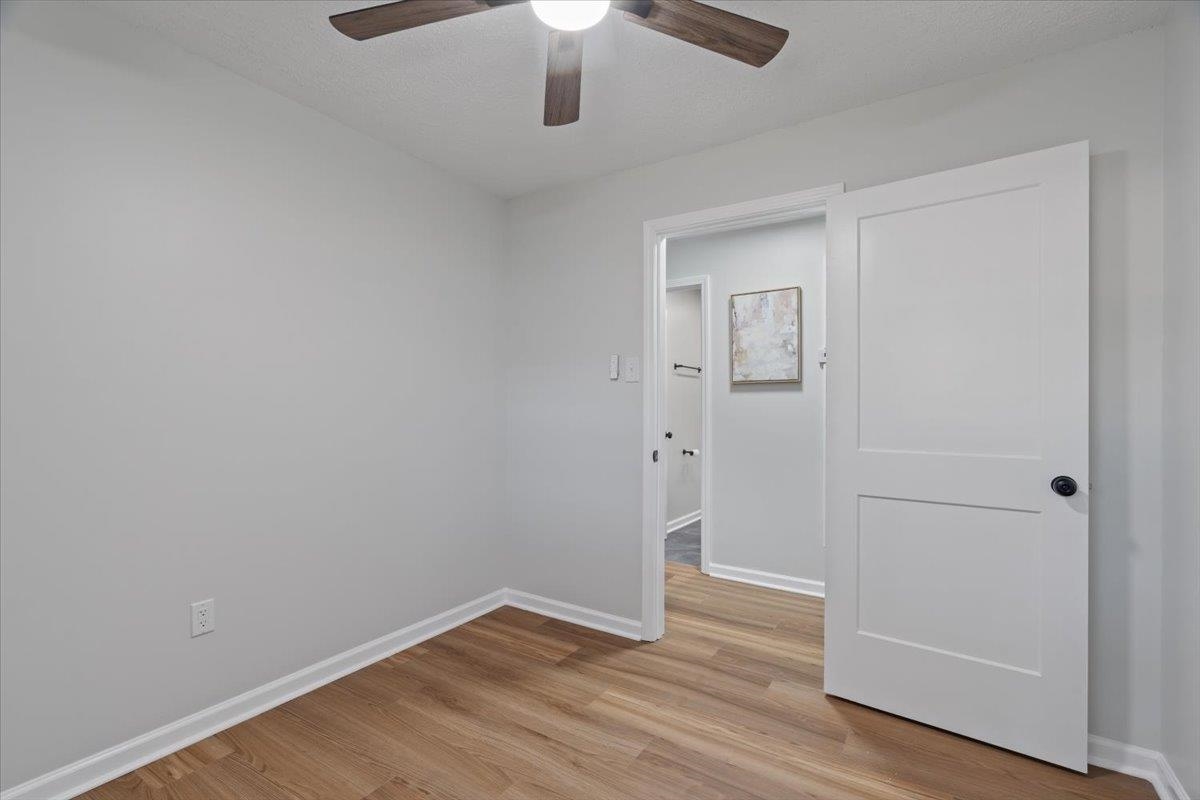 524 McDermitt Road Memphis, TN 38120 - Photo 12 of 32 Wood-finish flooring, ceiling fan, white trim, and a white interior door