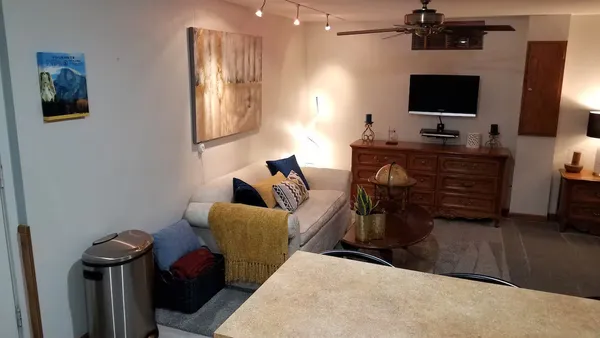 a living room with furniture and a flat screen tv