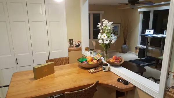 a dining room with furniture and chandelier
