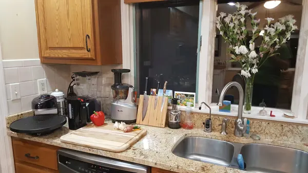 a kitchen with a sink and a stove top oven