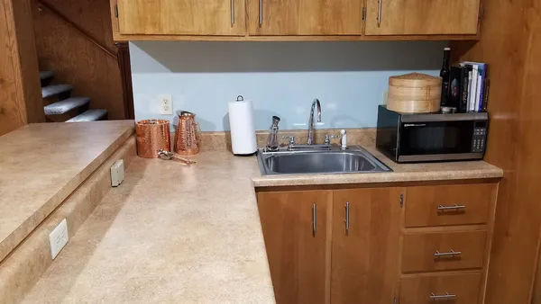 a kitchen with granite countertop a sink and a stove top oven