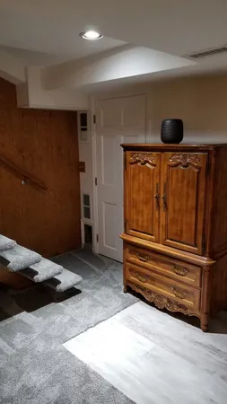 a bedroom with a bed and a chair