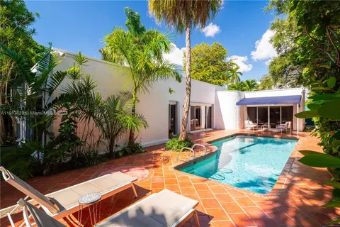 a view of a house with swimming pool and sitting area