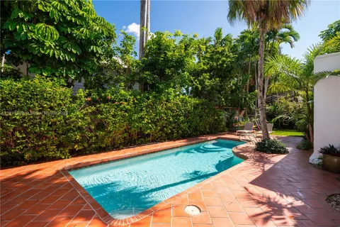 a view of a backyard with plants and a patio