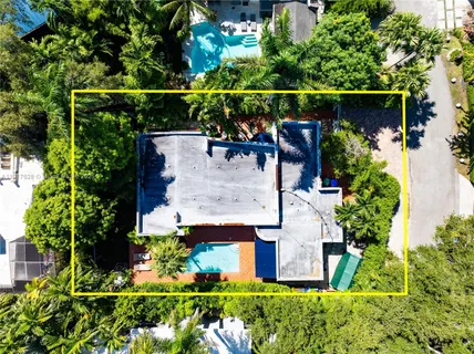 an aerial view of a house with lots of garden